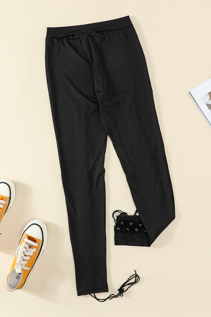 Woman wearing Black Grommet Lace Up Front Leggings in a stylish setting